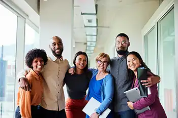 Group of diverse people standing together in a business hallway