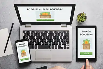 3 digital devices that each says Make A Donation.